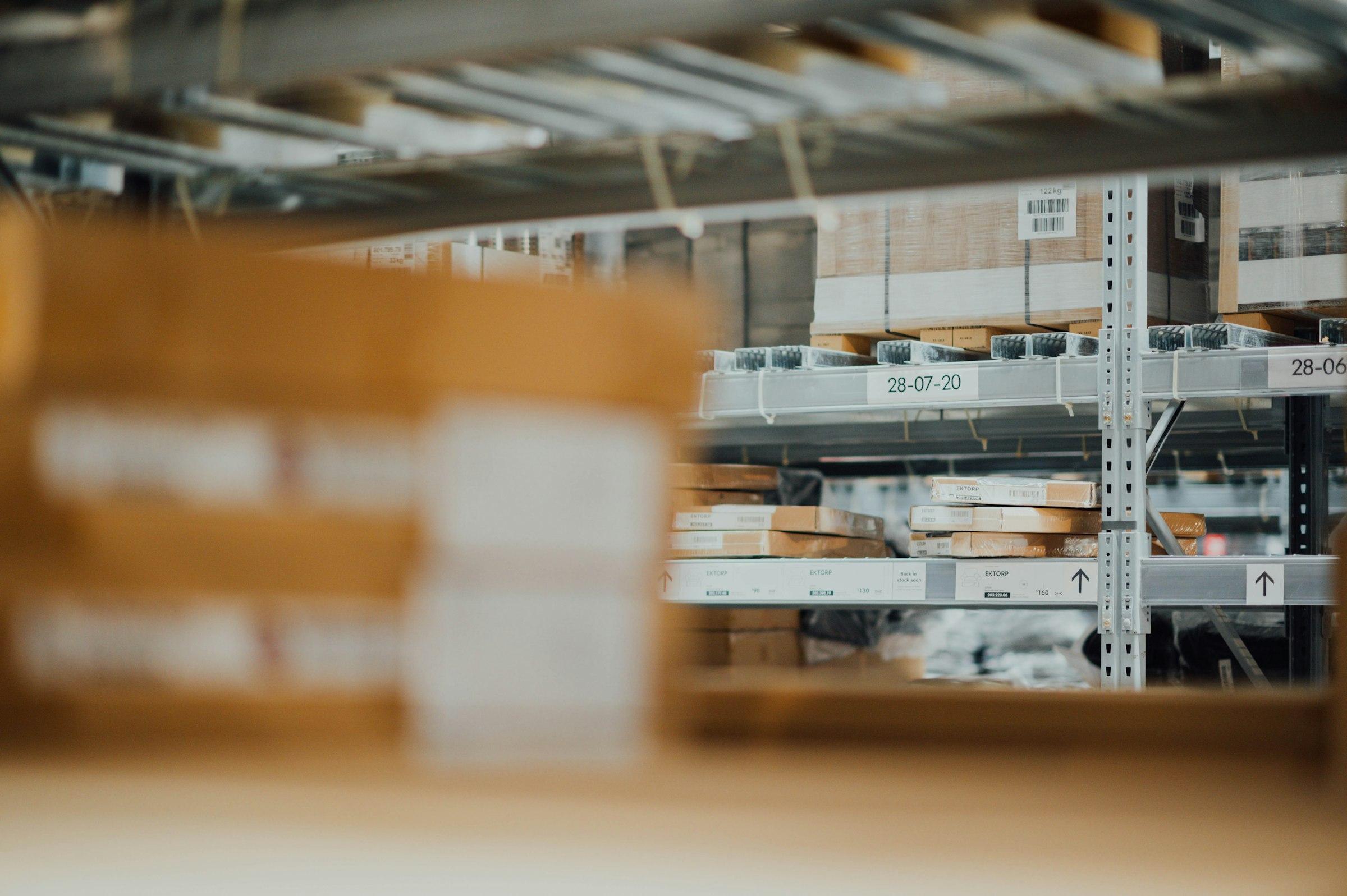 Warehouse racking stacked with goods, each shelf marked with its own location code